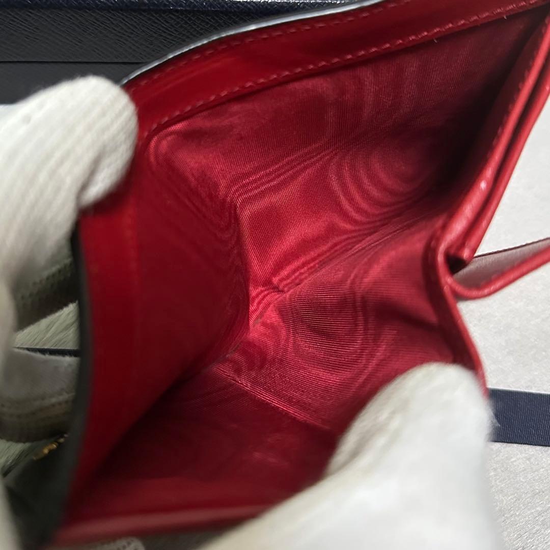 PRADA プラダ　折り財布　ゴールドロゴ　シボ革　バイカラー　赤　黒