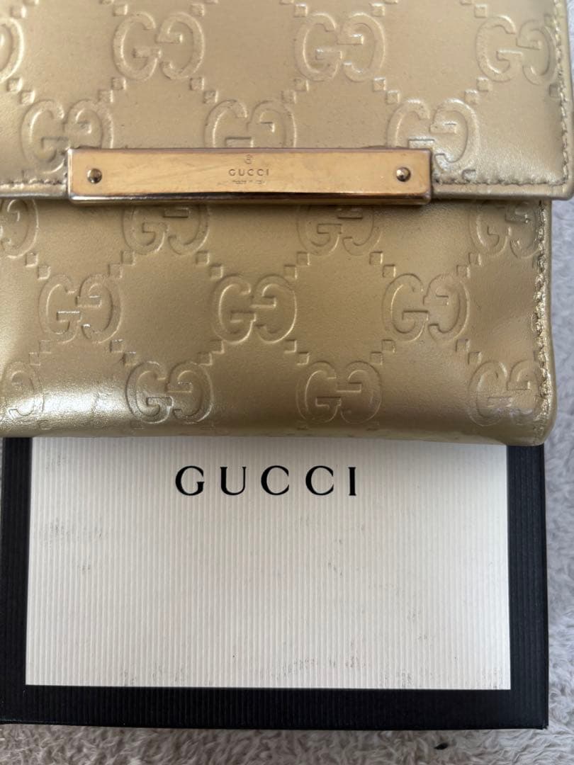 8*様 GUCCI ゴールド　二つ折り財布　グッチ　GGマーク